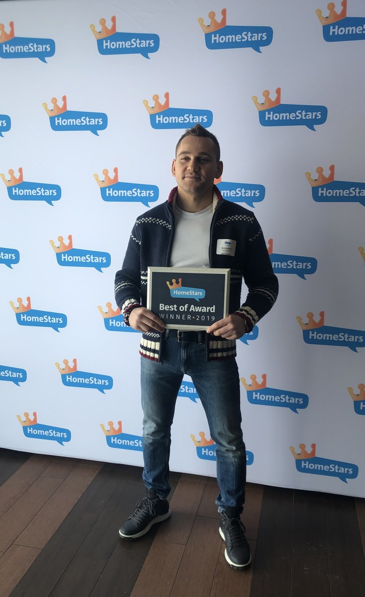 Denis Valasevich holding the framed HomeStars Best of Award Winner 2019 plaque for GTA TV Wall Mounting