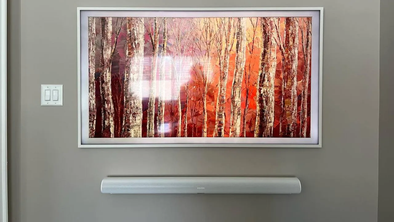 Samsung Frame TV with a white customisable bezel and a matching soundbar mounted level beneath it