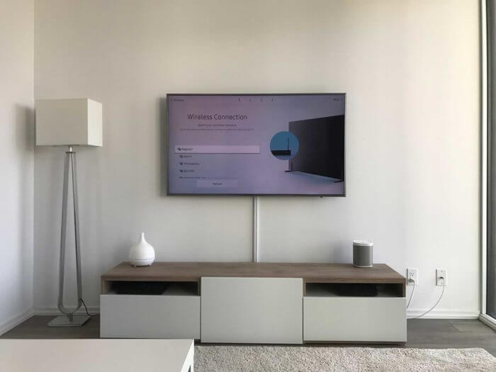 Wall-mounted TV with every cable concealed inside the wall and nothing visible below the screen