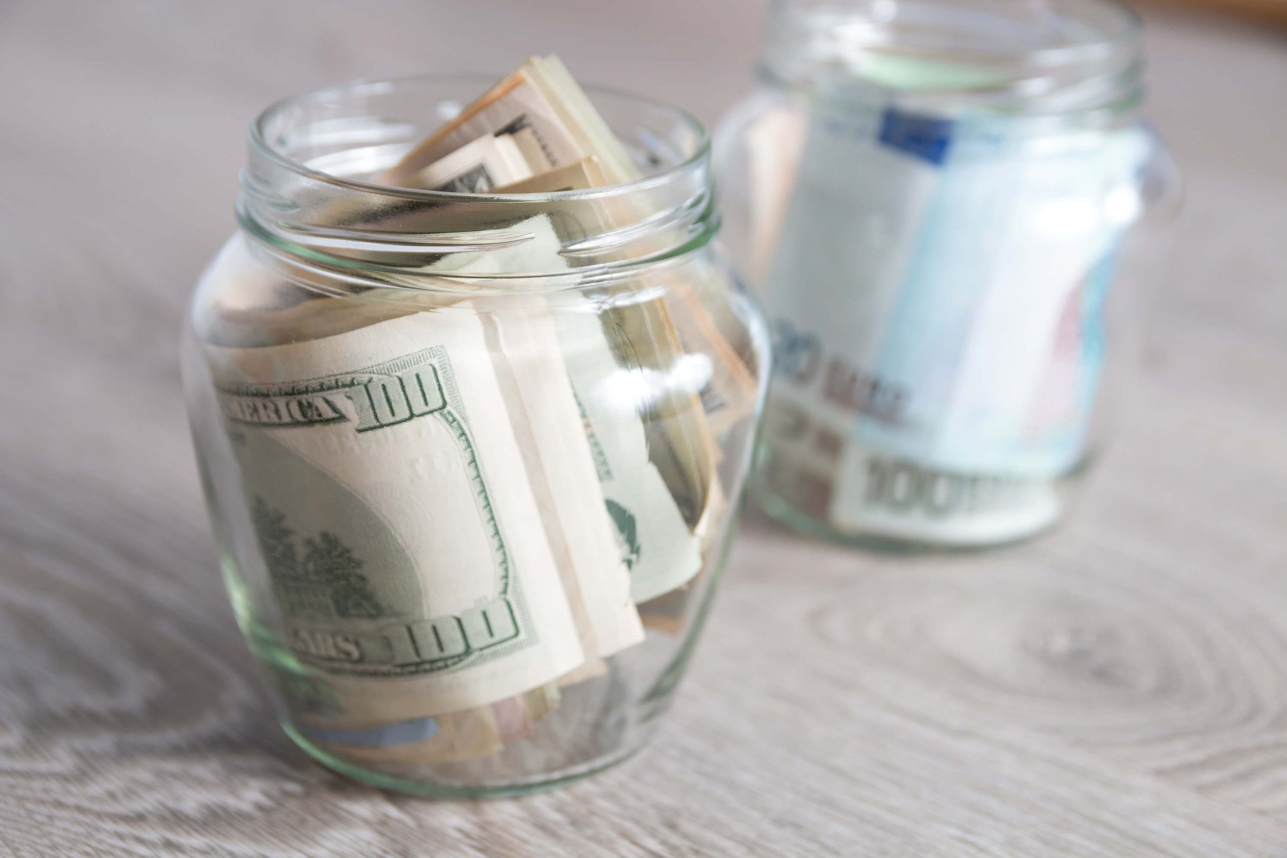 Money Dollars And Euro In Two Open Jars On Grey 2021 08 26 17 16 36 Utc 1